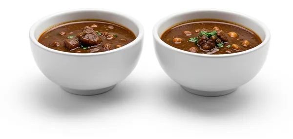 Two bowls of thick, dark stew, warm and filling for two.