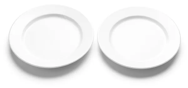 Two empty white plates, the last two guests who went without.