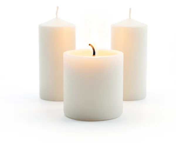 Three lit candles, set for a special dinner.