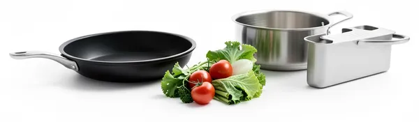 A frying pan, a pot and a fryer basket beside loose vegetables, every way to cook it at once.