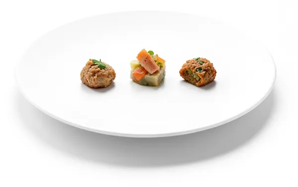 A large plate with three small, carefully made bites.