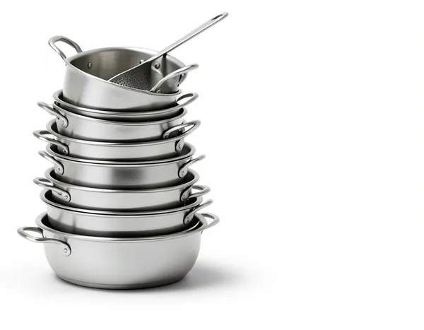 A tall stack of used pots and pans, a busy kitchen.